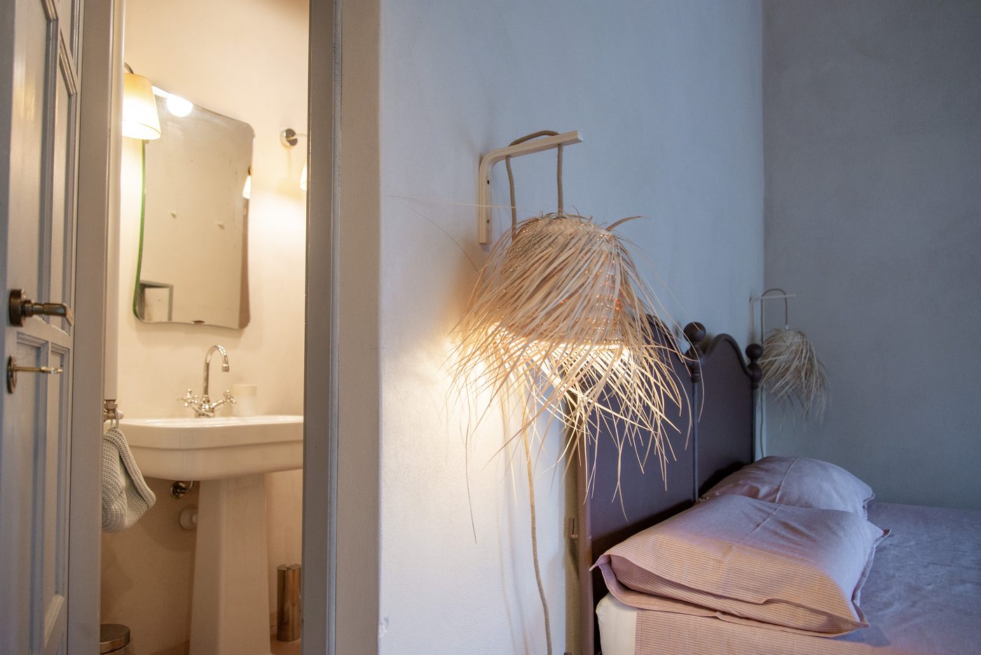 Double bed at Ca' Remurin with a view through to the en-suite bathroom, Verezzi, Liguria