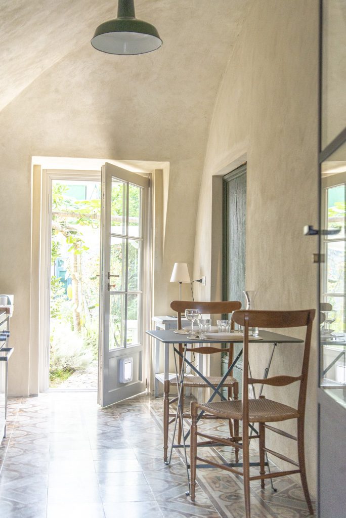 Kitchen and dining area at Ca' Remurin, Verezzi, with a glass door opening onto the private garden