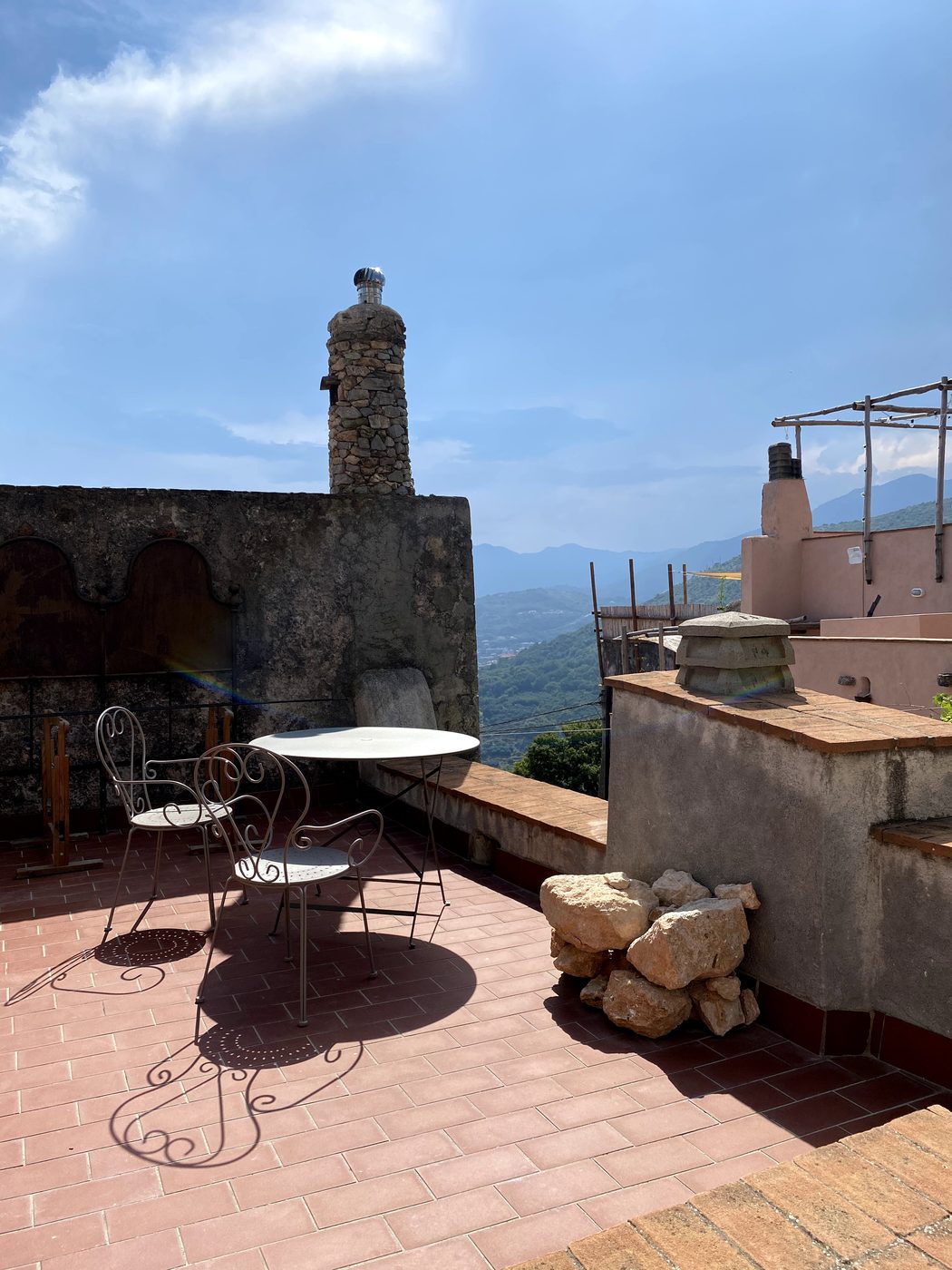 Private paved terrace at Ca' Remurin with bistro table and chairs, overlooking Verezzi and the Riviera Ligure di Ponente
